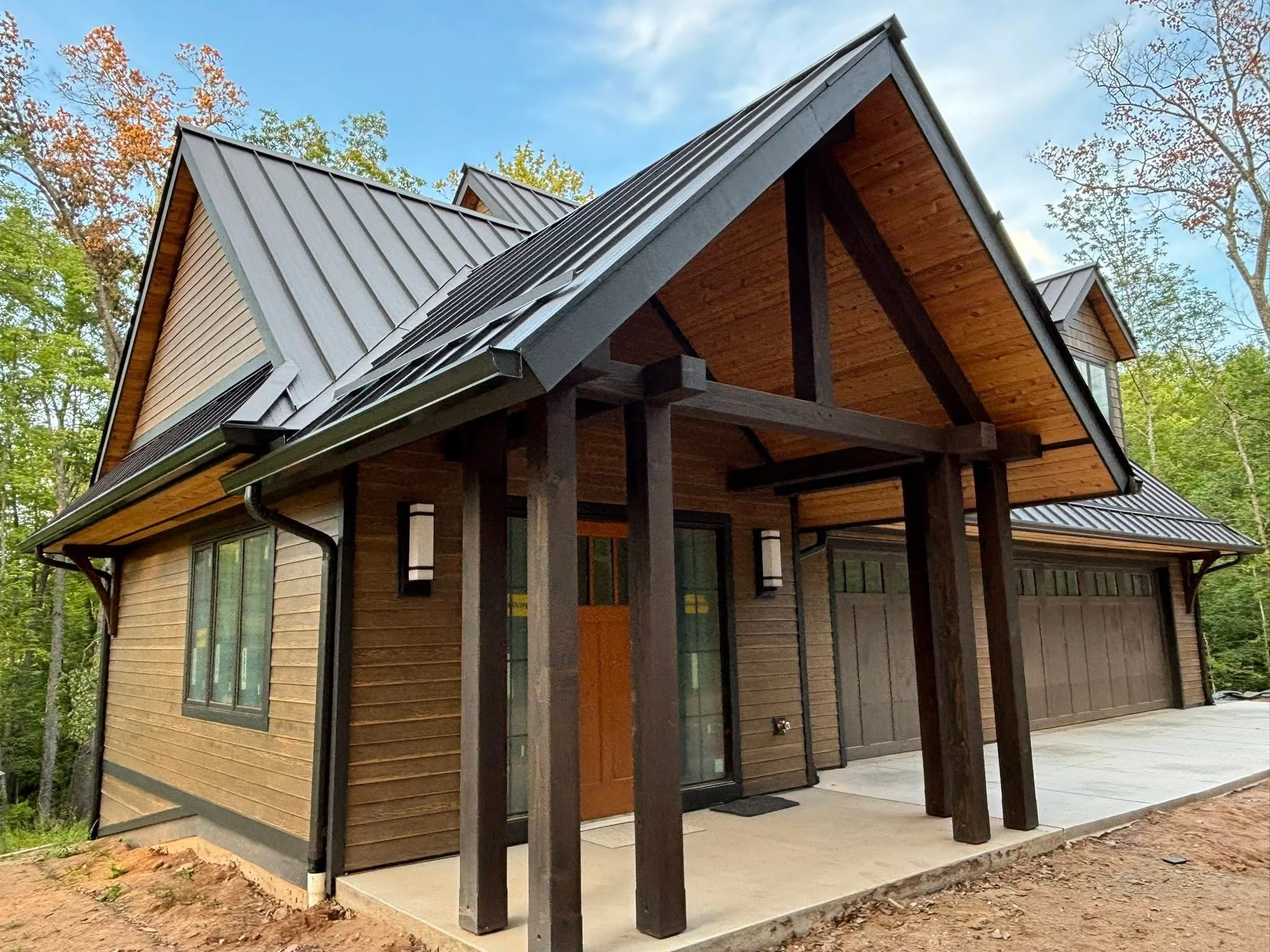 Large home exterior with seamless gutters and downspouts