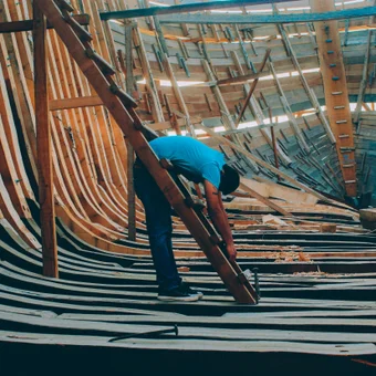 A crew member working on a roof edge during a gutter project